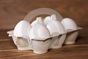 Six white eggs package in a carton