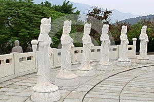 Six white marble Buddha statues in a natural ambiance, China