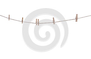 Six wood clothes pegs patterns hanging on brown string isolated on white background , clipping path
