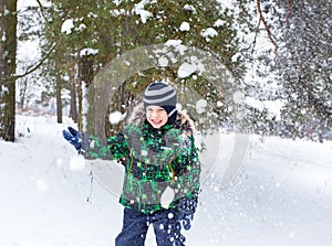 The six-year-old boy costs under a snow shower