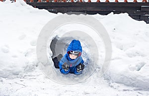 Six-year-old boy looking out from a snow