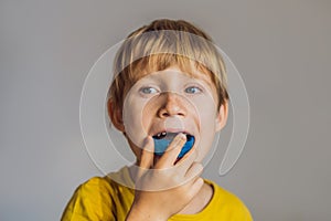 Six-year old boy shows myofunctional trainer. Helps equalize the growing teeth and correct bite, develop mouth breathing photo