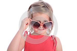 Six year old girl having fun with sunglasses