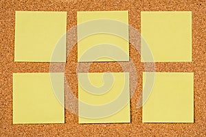 Six Yellow Post-it Sticky Notes on a cork board