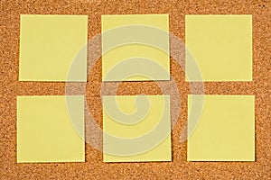Six Yellow Post-it Sticky Notes on a cork board