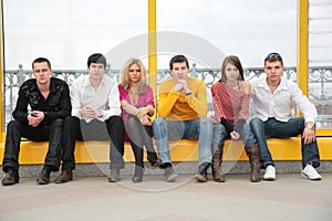 Six young persons sit