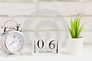 The sixth of October on the wooden calendar next to the alarm clock, the sixth day of the second autumn month