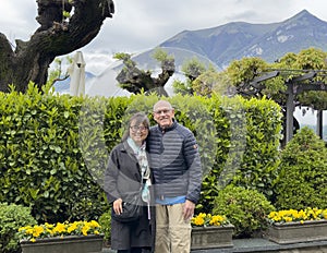 Sixty-five year-old Korean female tourist and her seventy-six year old Caucasian husband in Bellagio, Italy.