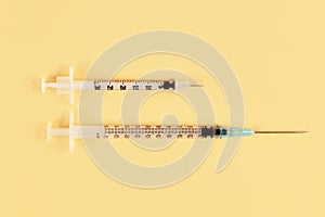 Size comparison between a 0,3 ml insulin syringe and a 1ml tuberculin syringe photo