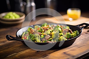 sizzling beef and broccoli skillet on a rustic table