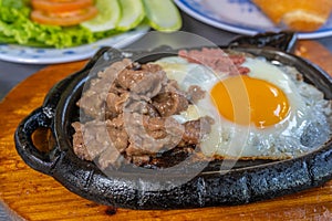 Sizzling beef steak served with sunny egg and salad