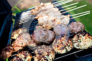 Sizzling burgers and chicken kebabs photo