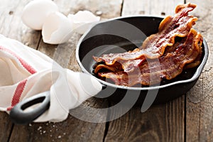 Sizzling hot bacon in a cast iron skillet