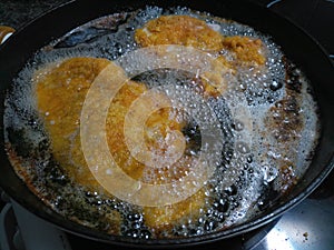 Sizzling hot weiner schnitzels deep frying