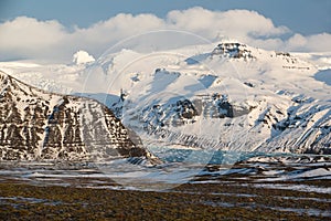 Skaftafell National park, glacier tongue down the valley in winter, blue ice and snow-capped mountains, Iceland