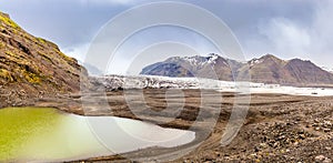 Skaftafellsjokull glacier with mountains and green lake in front, Vatnajokul national park, South Iceland