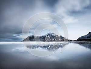 Skagsanden beach, Lofoten islands, Norway. Mountains, beach and clouds. Long exposure shot. Night time. Winter landscape near the