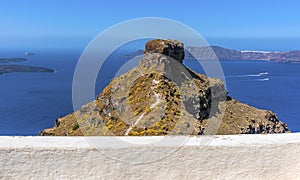 Skaros rock protrudes skywards with views towards Thirasia island photo