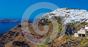 Skaros rock, white houses and the sea in background. Santorini, Greece.