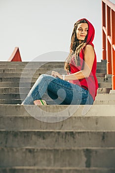 Skate girl on stairs with skateboard.