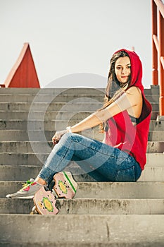 Skate girl on stairs with skateboard.