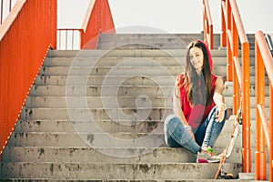 Skate girl on stairs with skateboard.