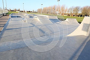 Skate park generic concrete ramps outside with blue sky