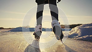 skate on the river. child playing on the river in winter. close-up legs child skating lifestyle on ice in winter on the