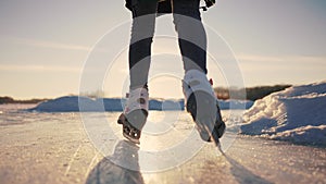 skate on the river. child playing on the river in winter. close-up legs child skating on lifestyle ice in winter on the