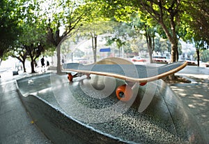 Skateboard on city skatepark ramp