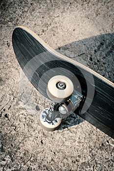 Skateboard on concrete floor in skatepark