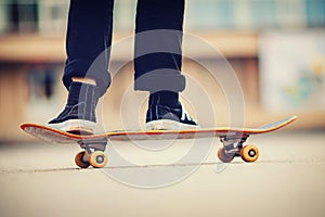 Skateboard man practices to ride on asphalt, learns tricks