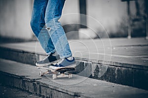 Skateboard man in shoes and jeans getting ready to jump kickflip olli from steps