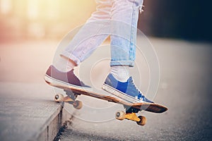 Skateboard man in shoes and jeans getting ready to jump kickflip olli from steps