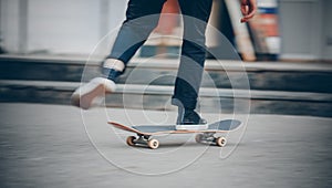 Skateboard man in shoes and jeans getting ready to jump kickflip olli from steps. Blurred background in motion