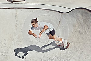 Skateboard, ramp and man skating at a park for exercise or practice at an urban city in Canada. Fitness, adventure and