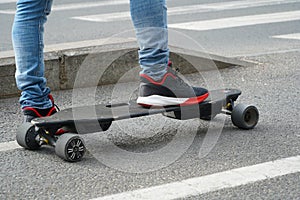 Skateboard. skateboard foot detail. young man waiting at the traffic light to cross on his skateboard.