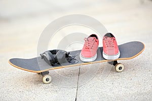 Skateboard and sneakers at skatepark