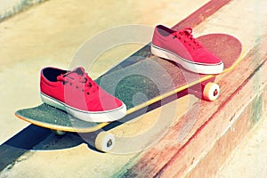 Skateboard and sneakers at skatepark