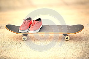 Skateboard and sneakers at skatepark