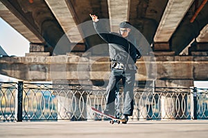 Skateboarder does ollie trick on street urban background