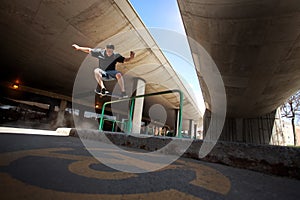 Skateboarder doing a Crooked Grind trick on a Rail photo
