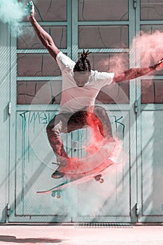 Skateboarder doing kickflip with colorful holi powder