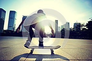 Skateboarder doing skateboarding trick ollie on city