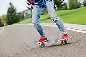 Skateboarder girl with skateboard outdoor. Skatebord at city, street