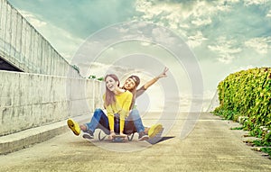 Skateboarder girlfriends roll down the slope