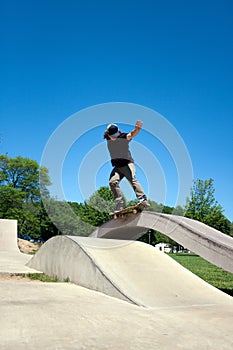 Skateboarder Grinding at the Skate