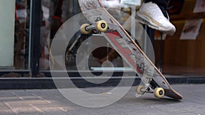 Skateboarder Jumps up and down on Skateboard Feet closeup slow motion