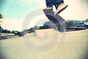 Skateboarder legs doing a track ollie