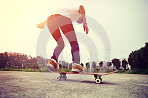 Skateboarder legs doing a track ollie photo